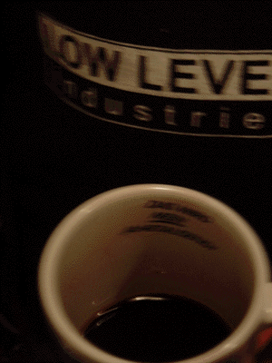 cup with red wine and black t-shirt and barely legible writing